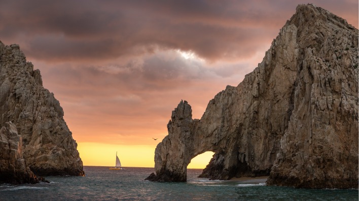 скалы море арка на закате