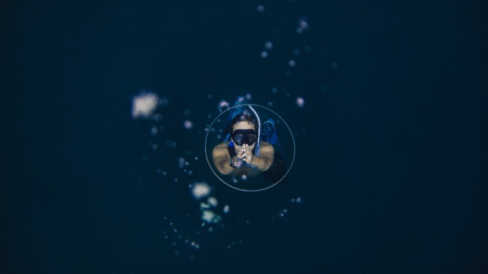 девушка дайвер под водой пузырьки