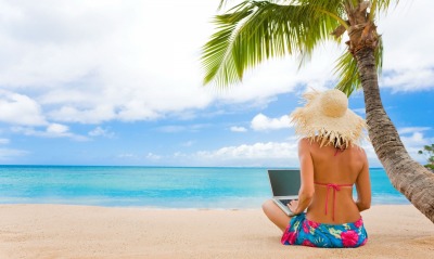 Девушка на берегу с ноутбуком
