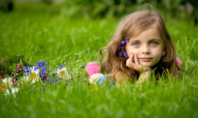 Девочка с цветами в траве