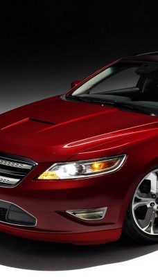 красный автомобиль Ford Taurus SHO