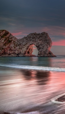 скалы арка закат море