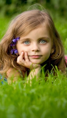 Девочка с цветами в траве