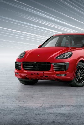 красный автомобиль Porsche Cayenne GTS